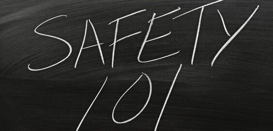 The words “Safety 101” written in all capital letters in white chalk on a blackboard with eraser streaks.