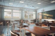An interior of a classroom with windows on one side of the room and desks throughout facing a blackboard.